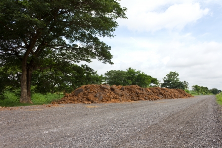 Are low in view of preparing the soil to repair the road in a rural area の写真素材