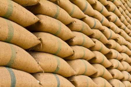 Old hemp sacks containing rice placed profoundly stacked in a row to keep up の写真素材