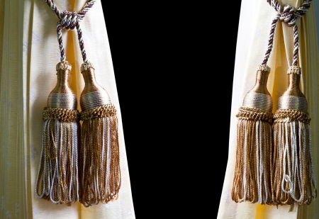 Pendulum made of gold thread on a yellow curtains in the background black の写真素材