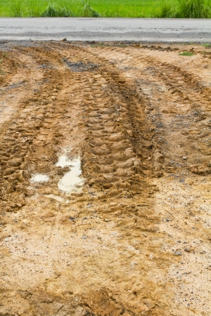 Wheel tracks of large vehicles used in agriculture, rural road on the ground の写真素材
