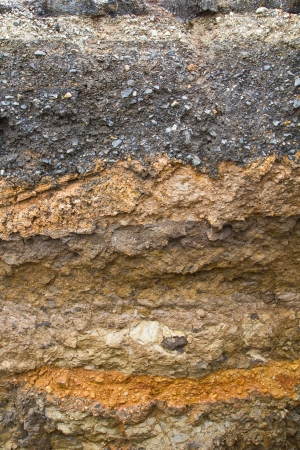 Soil under the asphalt surface of the road, which was severely eroded の写真素材