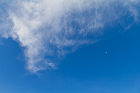 Background with white clouds on a beautiful blue sky in the daytime の写真素材