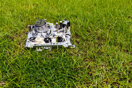 Mechanism of video tapes were discarded as trash laying on the grassの写真素材