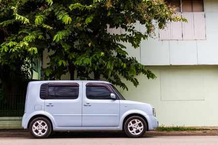 Van cars rectangular light blue four-door parked next to the house のeditorial素材