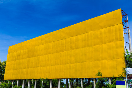 Low angle view of yellow blank billboards in the countryside.の写真素材