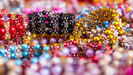 Background of colorful bead bracelets piled together so many different retailers.の写真素材