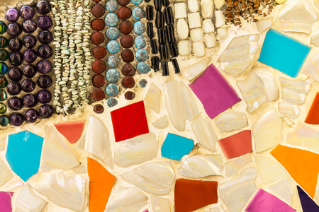 Background wall tiles cracked plate with colorful exotic patterns and debris.