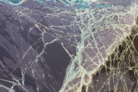 Close up background texture of cracked windshield damage from car accidents.の写真素材
