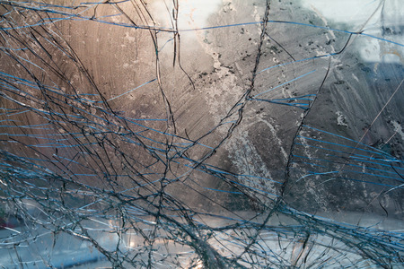 Close up on the inside of the windshield cracks visible light due to an accident.の写真素材