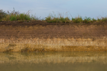 Background soil surface water flows through coastal erosion for a long time seen as a layer.の写真素材