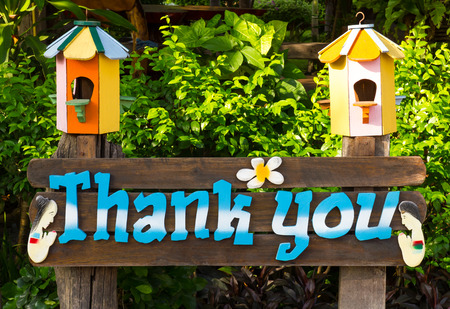 Font words "Thank you", which is made of wood, white and blue on a sign in the garden of a resort.の写真素材