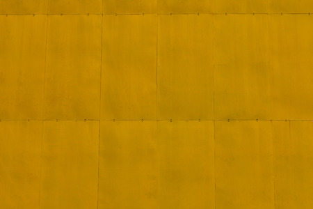 Texture background big yellow square steel plate, which is fixed with pins and joints smooth.の写真素材
