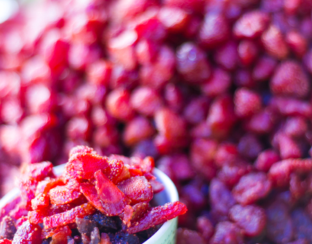 Close-up slices of dried strawberry, berry red, which lay piled everywhere.の写真素材