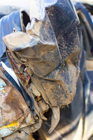 Close-up of a blue car, which was filled with mud demolished damaged due to an accident.の写真素材