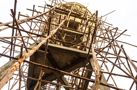 View beneath the wooden scaffolding, which tied for repairing concrete water tank.の写真素材