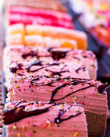 Background brown cream roll cake topped with chocolate and colorful snowflake.の写真素材