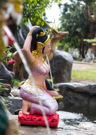 Statue of Mother Earth wearing a pink dress sitting squeezed tied bun legendary model in the river.の写真素材