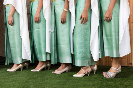 Close-legged woman is wearing a green patterned sarong Thailand lined poses beautifully.の写真素材