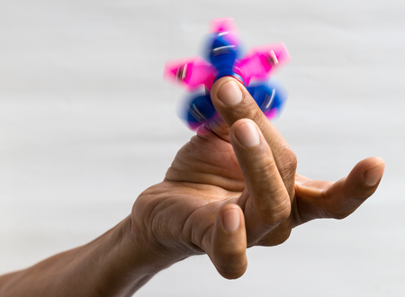 Close-up image of a pair of pink and blue star spinner, which is a popular toy in the fingers.の写真素材