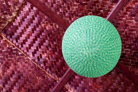 Low angle view Round lamp is made of green thread, beautifully weaved hanging on bamboo weave ceiling.の写真素材
