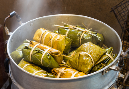 Bananas with Sticky Rice (Khao Tom Mat or Khao Tom Pad) in a steamer on a Thai country kitchen stove.の写真素材
