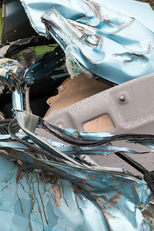 Background Close-up of light blue car damaged due to severe collision with another vehicle.の写真素材