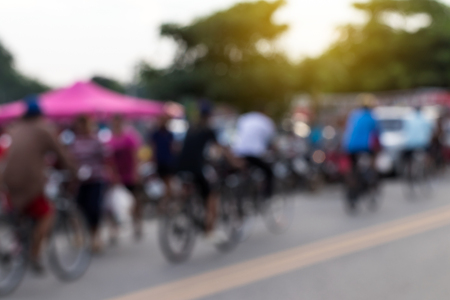 Blur people cycling through the evening market in rural Thailand.の写真素材