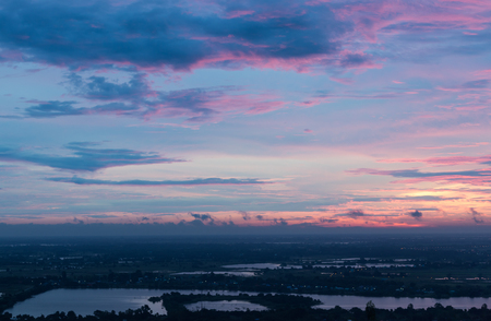 Scenery of sky with purple light early in the morning, above the river in rural Thailand.の写真素材