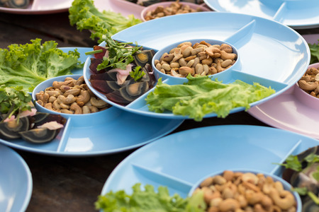Cashew dish with slices preserved egg tray in a circular hole in preparation to serve in the popular party.の写真素材