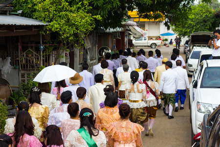 View from the back of the crowd wearing traditional Thai dress is marching Parece on the street in the city.のeditorial素材