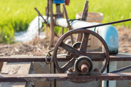 Close-up of pulley The old belt is rotating with a pumping engine from the groundwater to be used in agriculture.の写真素材