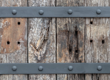 Close-up Background The wall is made of old logs that have been sunk for a long time until they are...
