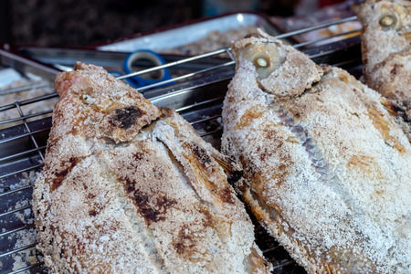 Close-up view of tilapia fillet, grilled and sprinkled with salt on the grill, which is popular in the market.の写真素材