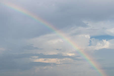 View clouds behind the rain and rainbow in the beautiful countryside.