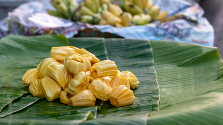Close-up picture of many jackfruit pieces on the green banana leaf on the basket, which is a popular fruit in the Thai market.の写真素材