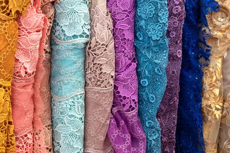 Close-up background, textured pattern, Thai fabric, floral pattern, various colors, colorful, which folds, rolls and overlaps vertically.の写真素材