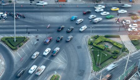 The view from above, cars and motorcycles are blurred, traveling on the highways, intersections commonly seen in the city.の写真素材