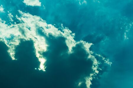 The background view is dark blue clouds in the sky which have sunlight passing over the Thai...