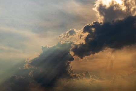 A view of overcast clouds floated in the sky, which was shining through in the evening.
