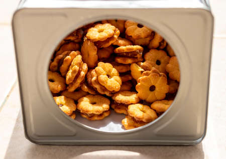 Close-up: Biscuits stuffed with many pineapple jams, which are junk food, are stacked on concrete...