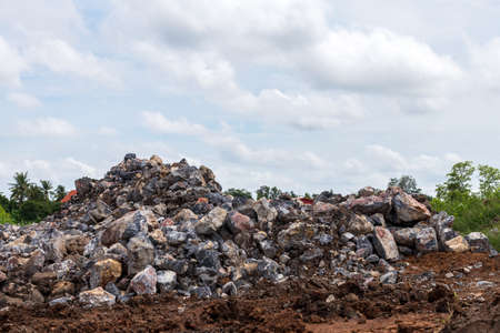 A close-up view of massive granite boulders that have been piled together on the ground in preparation for construction in one of the rural areas of Thailand.の写真素材