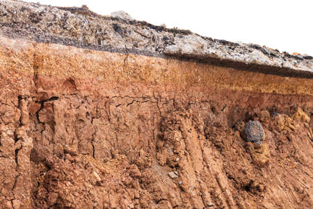 Background, close-up, low-angle view, a layer of dirt under a paved road excavated in rural...