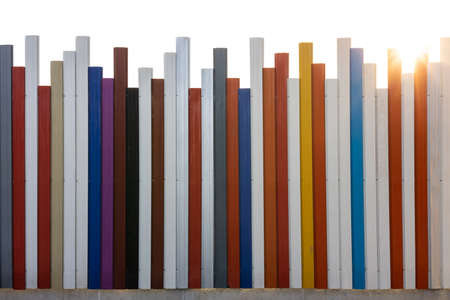 The background of the fence, walls, strips of steel slabs, in an uneven mix of colors, accentuated...