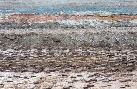 Close-up view of the background of the cross-sectional surface of a road basement that has been...