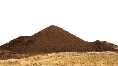 View of isolates of brown ray loam piled up like mountains on yellow sandy soil prepared to fill the area and use as organic material for forest plantations.の写真素材