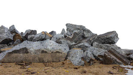 Isolated close-up view of a large pile of concrete rubble from a road demolition for renovation on a pile of sand against a white background.の写真素材