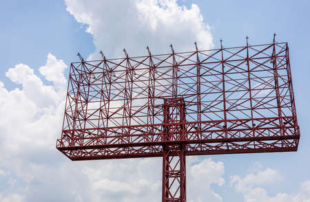 A low angle view of a beautiful white large new house erected on a mound with blue sky clouds as a...