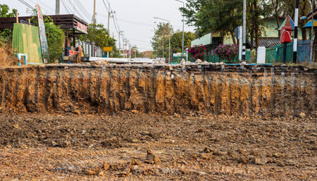 A low view from the ground to the cross section under paved roads that have been cut and renovated,...