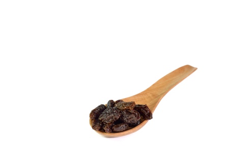 Raisin and wooden spoon isolated on white backgroundの写真素材
