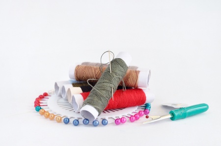 sewing accessories with pins, needle and threadの写真素材